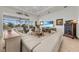 Living room features a large sectional sofa, a TV, and a view to the pool at 17745 Lucaya Dr, Lakewood Ranch, FL 34202