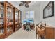 Home office with built-in bookcases, a desk, and a piano at 17745 Lucaya Dr, Lakewood Ranch, FL 34202