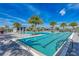 Community pool with palm trees, lounge chairs, and a shaded seating area at 17745 Lucaya Dr, Lakewood Ranch, FL 34202