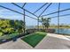 Peaceful screened patio with artificial turf and a picturesque lake view at 17745 Lucaya Dr, Lakewood Ranch, FL 34202