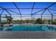 Stunning screened pool at dusk, offering a serene lake view at 17745 Lucaya Dr, Lakewood Ranch, FL 34202