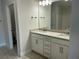 Bathroom with double vanity, granite countertop, and tiled floor at 5661 Gaffney Rd, North Port, FL 34286
