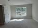 Bright bedroom featuring a window with natural light and neutral carpet at 5661 Gaffney Rd, North Port, FL 34286