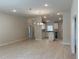 Open floor plan showcasing the living area and kitchen with white cabinets and neutral color palette at 5661 Gaffney Rd, North Port, FL 34286