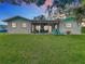 Home's exterior view, showcasing a screened porch and lawn at 1216 Angela Maria Rd # 2, Sarasota, FL 34243