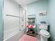 Stylish bathroom with a shower-tub combination and decorative shelving for towels at 1216 Angela Maria Rd # 2, Sarasota, FL 34243