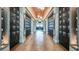 Long hallway with wine storage lockers on each side at 3118 Tramonto Ct, Bradenton, FL 34211