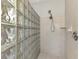 Clean shower with glass block wall and neutral tile at 4417 Mcintosh Lake Ave, Sarasota, FL 34233