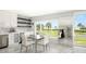 Bright dining area with glass table and white chairs, overlooking scenic water views at 4600 Gulf Of Mexico Dr # 203, Longboat Key, FL 34228