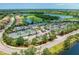 Aerial view of community amenities, including tennis courts, pool, and clubhouse at 323 Winding Brook Ln # 102, Bradenton, FL 34212