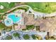 Top-down view of community pool and clubhouse with surrounding landscape at 323 Winding Brook Ln # 102, Bradenton, FL 34212