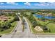 Community entrance with palm trees and landscaping at 323 Winding Brook Ln # 102, Bradenton, FL 34212