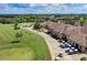 Aerial view of clubhouse, golf course, and parking lot at 323 Winding Brook Ln # 102, Bradenton, FL 34212