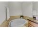 Bathroom with soaking tub and granite vanity at 323 Winding Brook Ln # 102, Bradenton, FL 34212