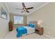 Guest bedroom with queen bed and ceiling fan at 323 Winding Brook Ln # 102, Bradenton, FL 34212