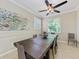 Spacious dining room with large wood table and ceiling fan at 323 Winding Brook Ln # 102, Bradenton, FL 34212