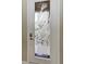 White front door; etched glass detail, modern door hardware at 323 Winding Brook Ln # 102, Bradenton, FL 34212