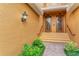 Front entrance with double doors, lush landscaping, brick walkway at 323 Winding Brook Ln # 102, Bradenton, FL 34212