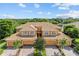 Tan three-unit townhome building; attractive rooflines, lush landscaping at 323 Winding Brook Ln # 102, Bradenton, FL 34212