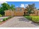 Three-car garage townhome; brick paver driveway, manicured landscaping at 323 Winding Brook Ln # 102, Bradenton, FL 34212