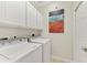 Laundry room with washer, dryer, and cabinets at 323 Winding Brook Ln # 102, Bradenton, FL 34212