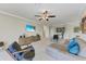 Living room with sectional sofa, large TV, and access to balcony at 323 Winding Brook Ln # 102, Bradenton, FL 34212