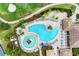 Relaxing community pool with surrounding lounge chairs and landscaping at 323 Winding Brook Ln # 102, Bradenton, FL 34212