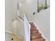 Elegant staircase; hardwood steps, white railing, neutral walls at 323 Winding Brook Ln # 102, Bradenton, FL 34212