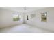 Bright, empty bedroom with three windows providing natural light at 8993 Bantry Bay Blvd, Englewood, FL 34224