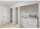 Functional laundry area with washer, dryer, and utility sink for added convenience at 8993 Bantry Bay Blvd, Englewood, FL 34224
