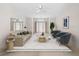 Living room with double doors leading outside, tastefully staged with modern furniture and decor at 8993 Bantry Bay Blvd, Englewood, FL 34224