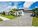 Single-Gathering home with a gray garage and landscaped front yard at 17011 Sweetwater Village Dr, Bradenton, FL 34211