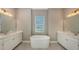 Bathroom with free-standing tub and double vanity at 21285 Holmes Cir, Venice, FL 34293