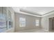 Bright bedroom with two windows and neutral walls at 21285 Holmes Cir, Venice, FL 34293