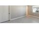 Bright bedroom with neutral walls, tile floors, and a window with blinds at 21285 Holmes Cir, Venice, FL 34293