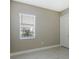 Simple bedroom with neutral walls, tile floors, and a window with blinds at 21285 Holmes Cir, Venice, FL 34293