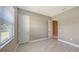 Bright bedroom with neutral walls, tile floors, and a window with blinds at 21285 Holmes Cir, Venice, FL 34293