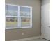 Bright bedroom with neutral walls, tile floors, and a large window with blinds at 21285 Holmes Cir, Venice, FL 34293