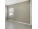 Simple bedroom with neutral walls, tile floors, and a window with blinds at 21285 Holmes Cir, Venice, FL 34293