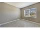 Bright bedroom with neutral walls, tile floors, and a large window at 21285 Holmes Cir, Venice, FL 34293