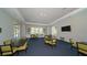 Clubhouse common area with tables, chairs, and a large TV at 21285 Holmes Cir, Venice, FL 34293