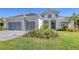Two-story house with gray walls, gray roof, and landscaping at 21285 Holmes Cir, Venice, FL 34293