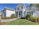 Two-story house with gray and white walls, gray roof, and landscaping at 21285 Holmes Cir, Venice, FL 34293