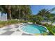 Community hot tub with checkered tile deck and lush landscaping at 21285 Holmes Cir, Venice, FL 34293