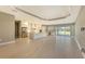 Open concept kitchen with white cabinets, large island, and stainless steel appliances at 21285 Holmes Cir, Venice, FL 34293