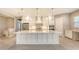 Spacious kitchen with island, white cabinets, and stainless steel appliances at 21285 Holmes Cir, Venice, FL 34293
