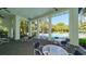 Relaxing pool area with tables, chairs, and a view of lush landscaping at 21285 Holmes Cir, Venice, FL 34293