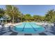 Community pool with lap lanes, lounge chairs, and palm trees at 21285 Holmes Cir, Venice, FL 34293