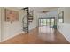 Bright living room features a spiral staircase and sliding glass doors leading to a beautiful outdoor view at 1026 Bird Bay Way # 276, Venice, FL 34285