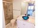 Bathroom with a glass enclosed shower and a vanity with blue vessel sink at 5027 Kestral Park Dr # 64, Sarasota, FL 34231